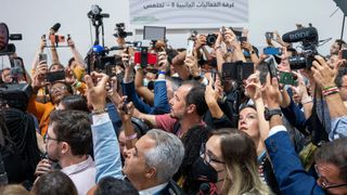 Participants and journalists take photos and videos during the arrival of the new Brazilian President Lula da Silva