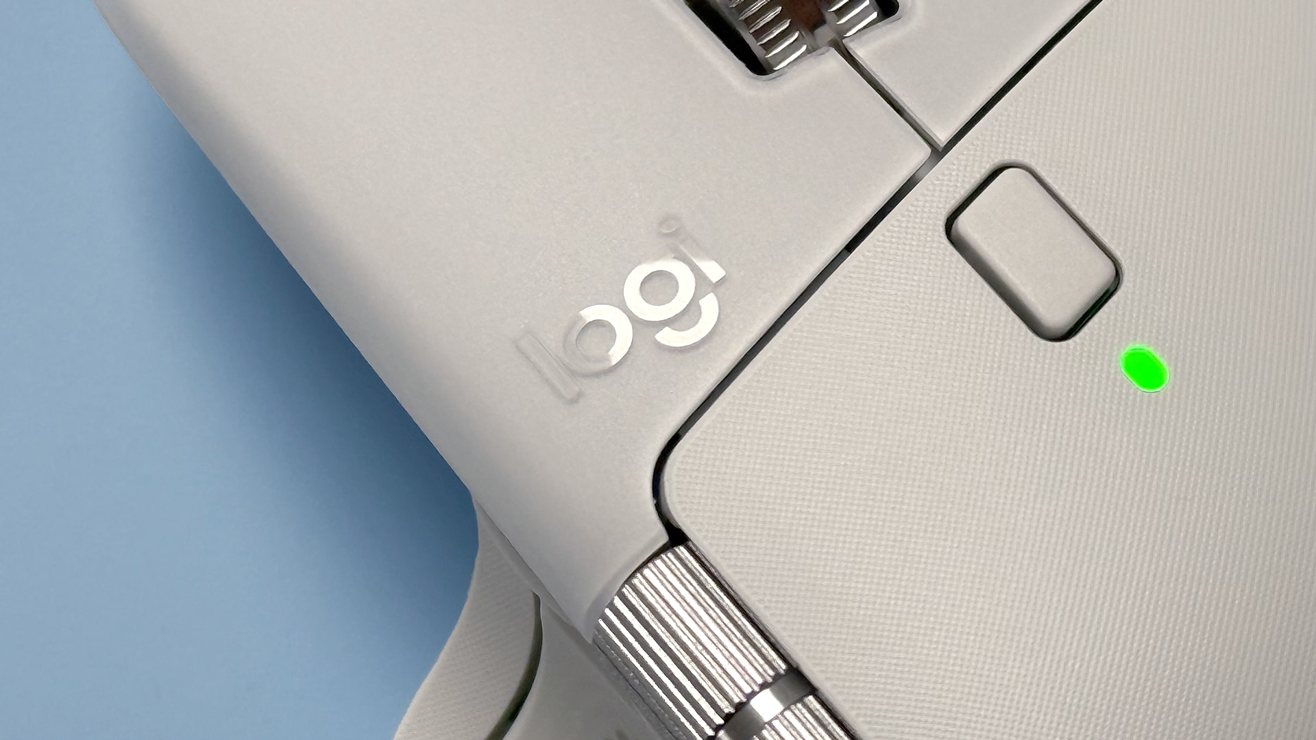 The Logitech MX Master 4 mouse against a blue background.