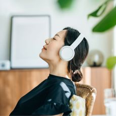 How to switch off: A woman sat relaxing with her headphones on