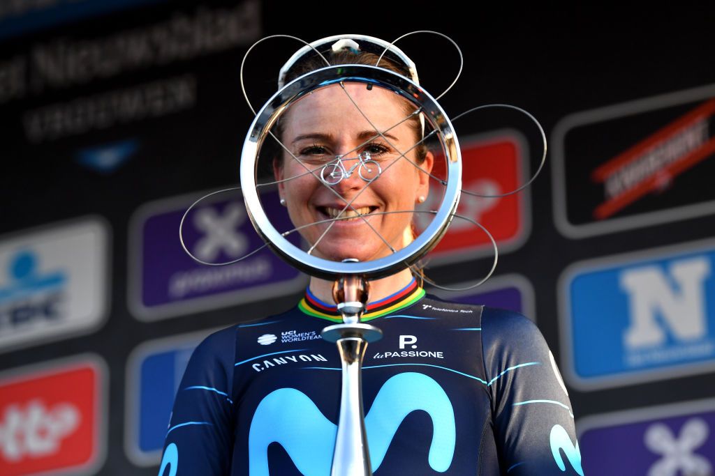 NINOVE BELGIUM FEBRUARY 26 Annemiek Van Vleuten of Netherlands and Movistar Team Women poses at podium with race trophy as winner after the 17th Omloop Het Nieuwsblad 2022 Womens Race a 128km race from Ghent to Ninove OHN22 FlandersClassic WorldTour on February 26 2022 in Ninove Belgium Photo by Luc ClaessenGetty Images