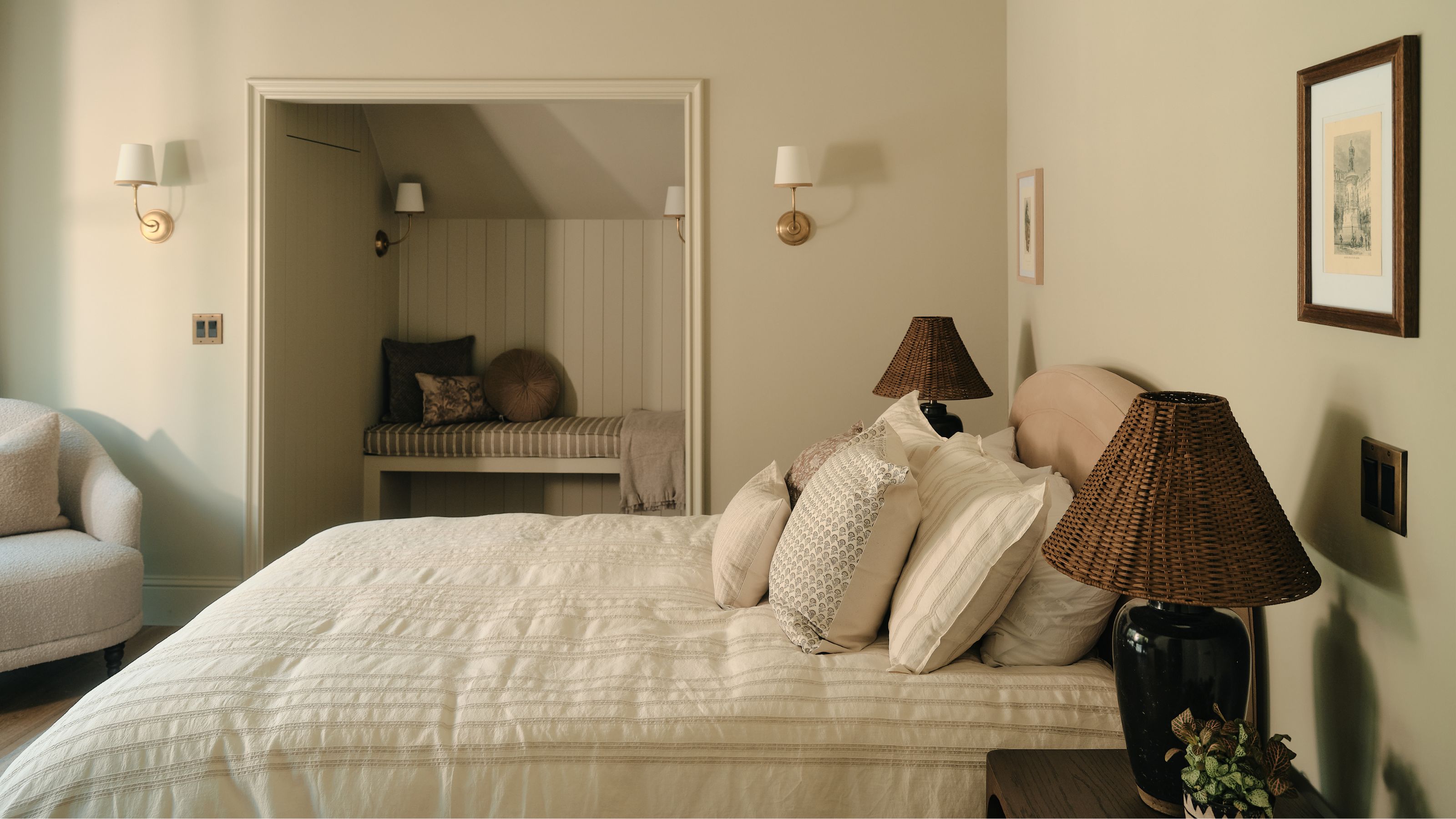 a calm neutral bedroom with a recessed reading nook