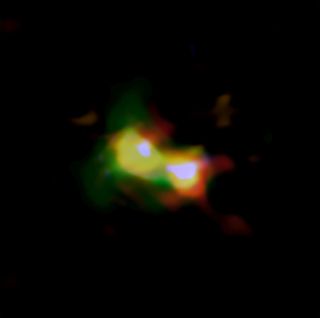 A composite image of the object B14-65666 shows the distributions of dust (red), oxygen (green) and carbon (blue), observed by ALMA. Stars (white) were observed by the Hubble Space Telescope.