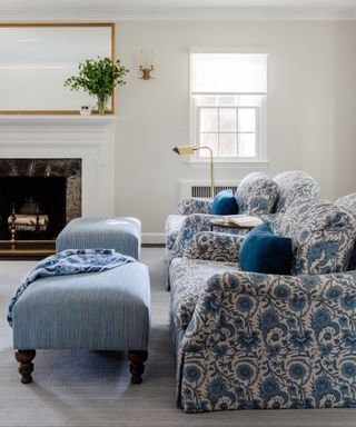 Cream living room with fireplace and blue patterned sofa