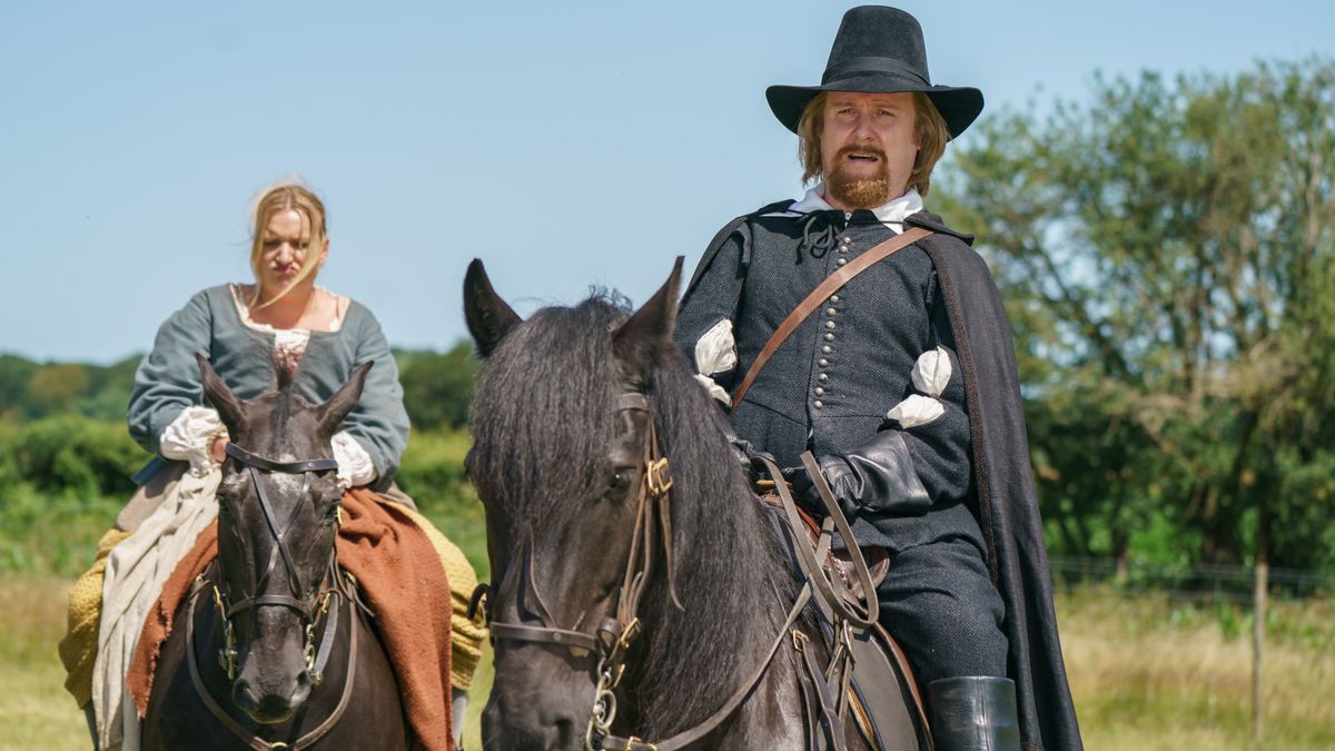 Thomasine Gooch (Daisy May Cooper) and Gideon Bannister (Tim Key) on horseback in The Witchfinder.