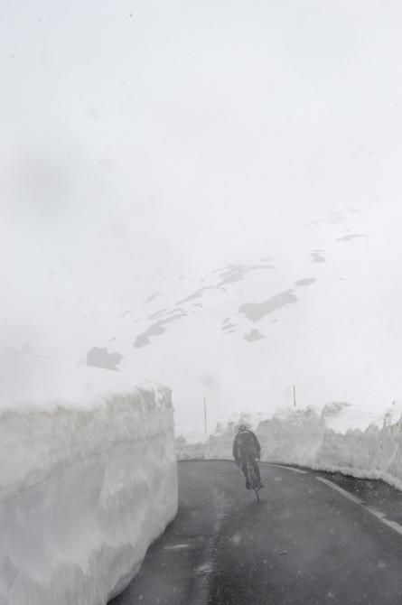 A BMC rider in between tall banks of snow on the Gavia pass