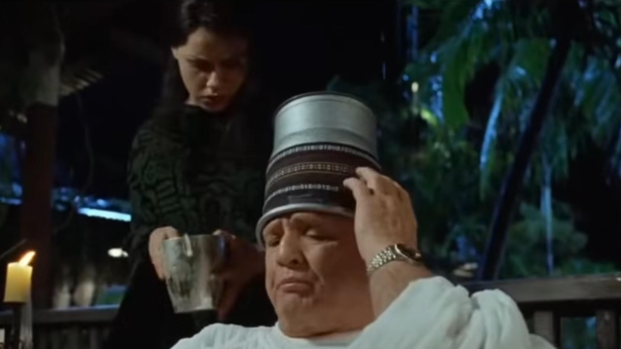 Marlon Brando holding onto his ice bucket hat in The Island of Dr. Moreau