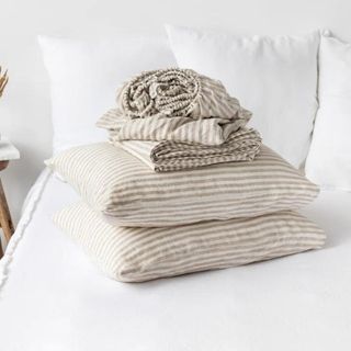 Natural Linen Striped Sheets on a white bed.