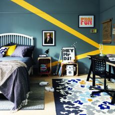 Teenage boy's bedroom done up in blue and yellow