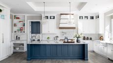 kitchen with luxe cooker hood and large blue island