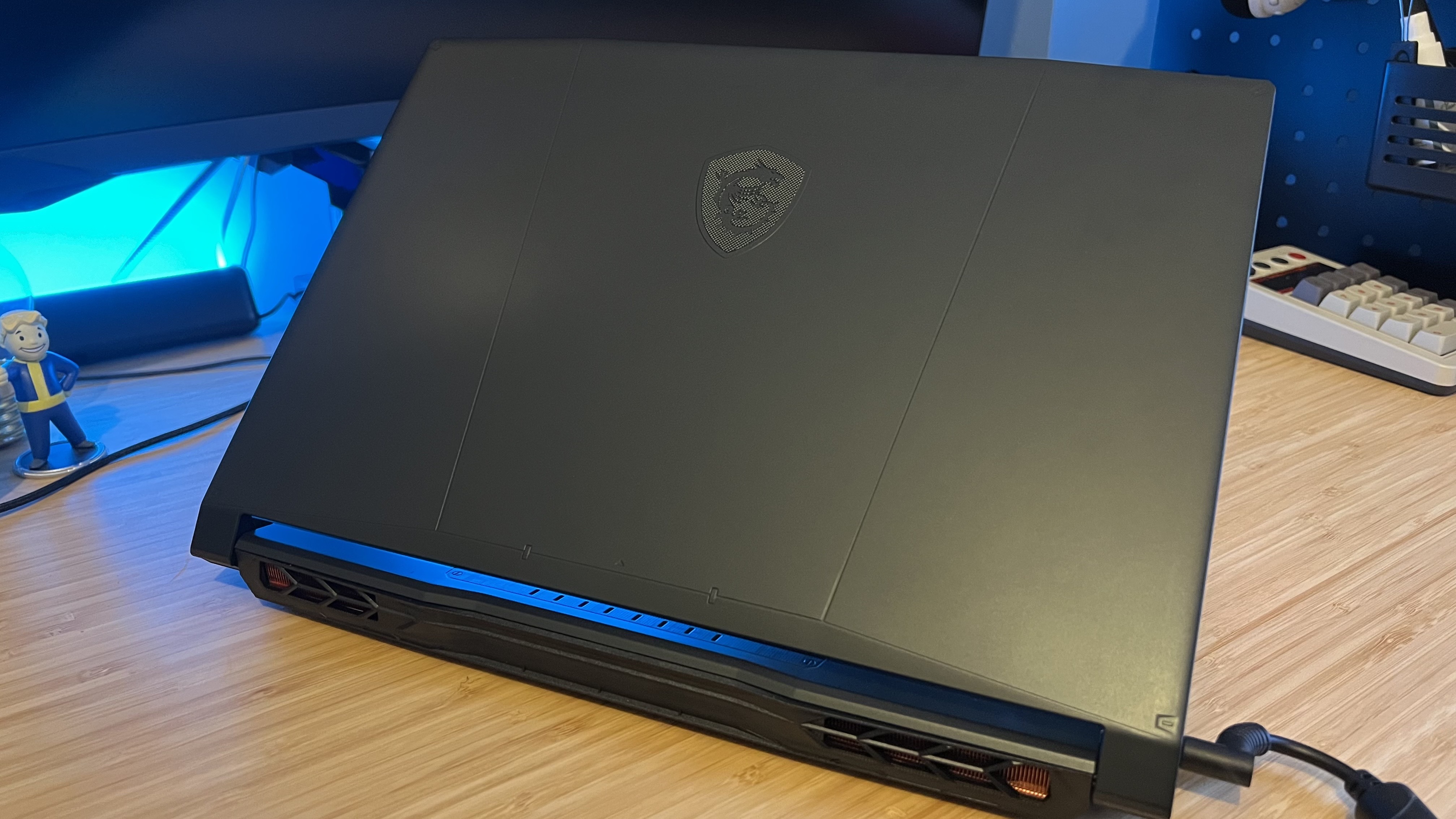 Back of MSI Katana gaming laptop lid on a wooden desk