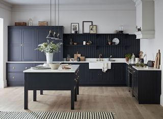 kitchen with dark cabinets and white worktops