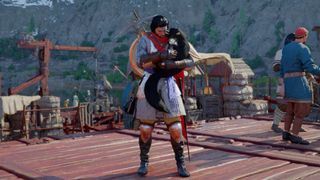 Kliff cuddles a cat in Crimson Desert.