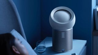 Dyson Pure Cool Me on bedside table next to sleeping woman