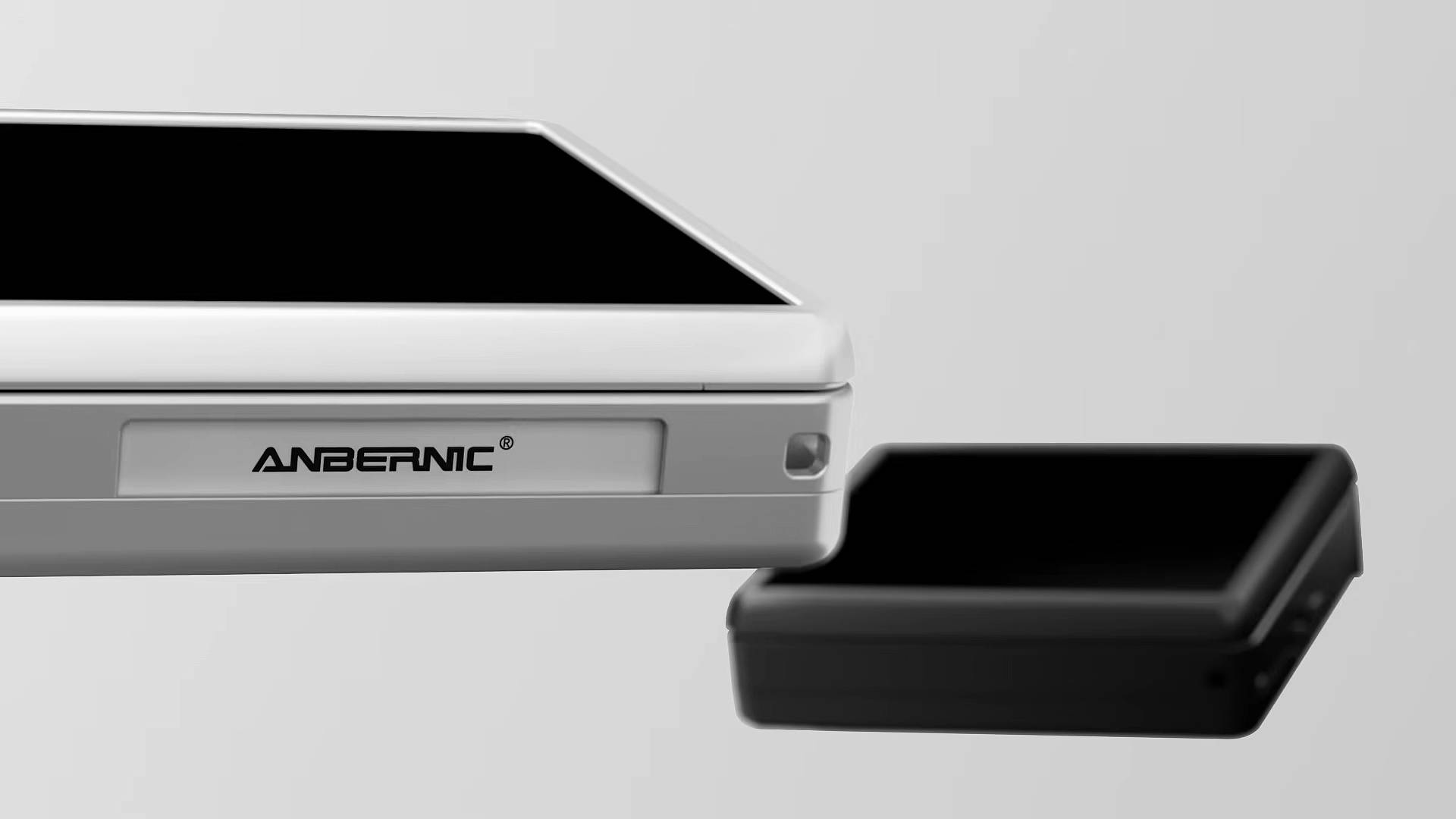 Angled view of Anbernic RG Rotate black and white with gray backdrop.