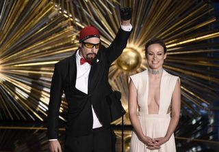 Sacha Baron Cohen, dressed as Ali G, and Olivia Wilde at the Oscars