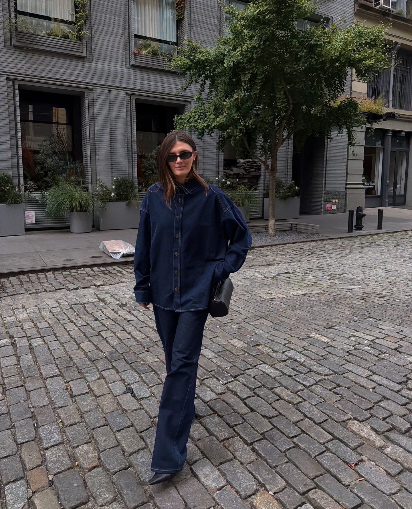 An image of a woman wearing denim shirt outfit 2026