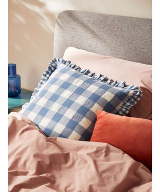 blue gingham cushion on bed