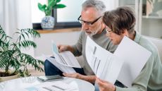 man and woman looking at savings account papers