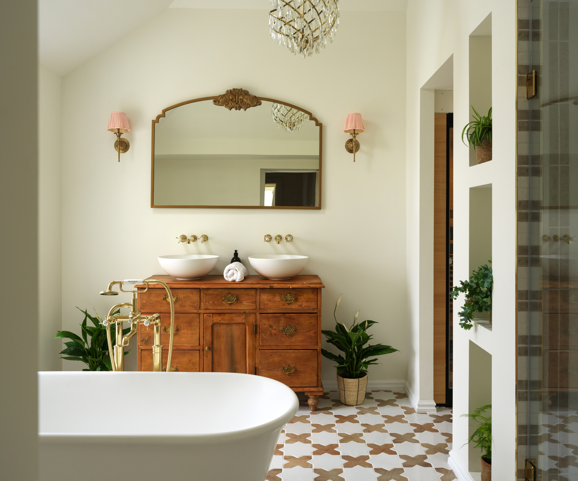 bathroom with built in shelving, freestanding vintage vanity, bath, two sinks and tiled floor