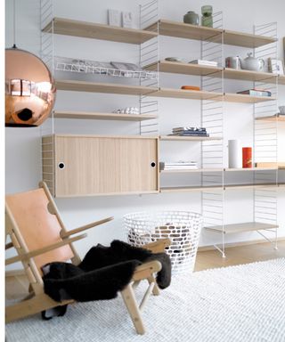 String shelving system in ash with white wall and floor panels - String Furniture