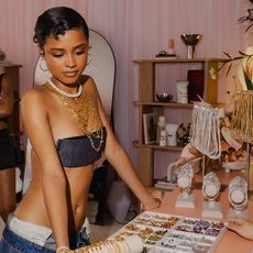 tyla wers denim bandeau and denim bottoms while styling her look with cascading necklaces 