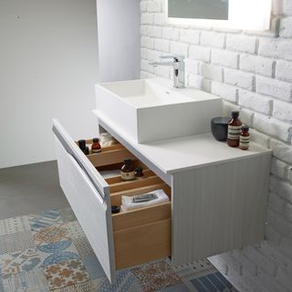 Bathroom sink with drawer opening to show organised products
