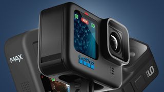 Three GoPro action cameras on a blue background
