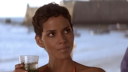 Halle Berry sipping a mojito in Die Another Day's beach scene. 