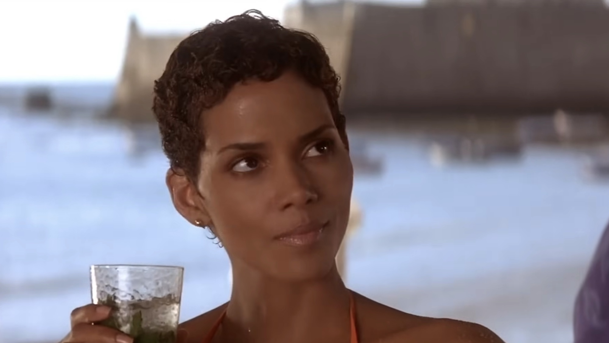 Halle Berry sipping a mojito in Die Another Day's beach scene. 