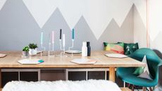 dining table with grey mural painted on wall behind