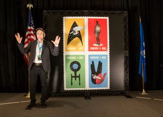 "Star Trek" actor Walter Koenig (Pavel Chekov) gives the Vulcan salute with the U.S. Postal Service's new Trek stamps honoring the TV series' 50th anniversary. 
