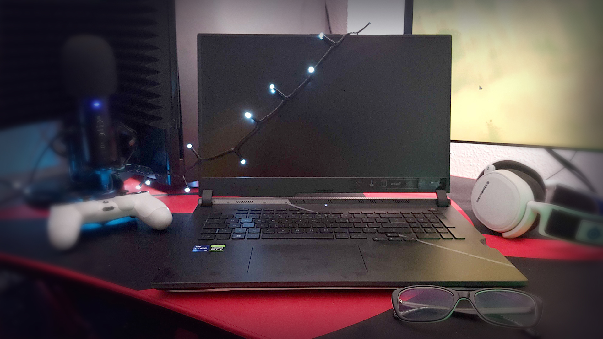 The Asus ROG Strix Scar 17 (2022) from the front, on a desk with some peripherals.