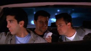 Matt LeBlanc as Joey and Matthew Perry as Chandler sit in the back of a car on Friends.