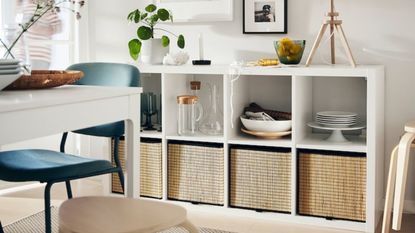 White cube shelving units with basket inserts and decorative items in dining room