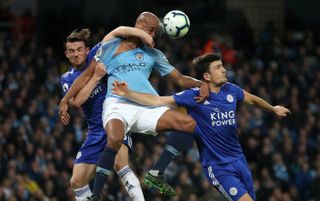 Vincent Kompany battles for the ball with Leicester duo Ben Chilwell and Harry Maguire