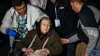 An elderly civilian being evacuated from the besieged steel plant