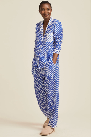 woman wearing shirt and trousers pyjama set with leaf print all over