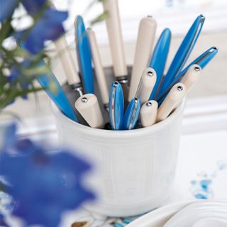 Blue and white cutlery in a cutlery holder