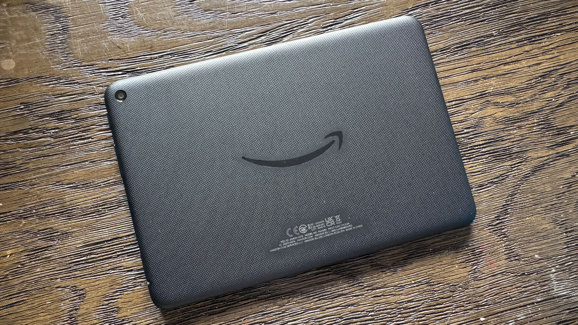 Amazon Fire HD 8 tablet face down on wooden surface
