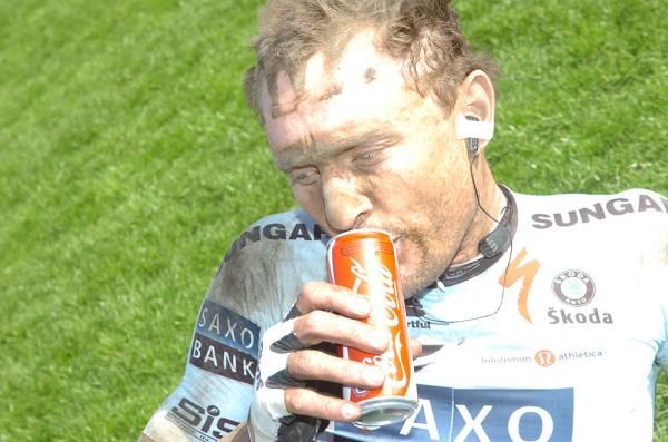 Baden Cooke has a Coke and rues his broken cleat.