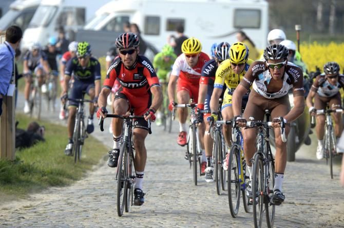 The peloton looks for the best line on the cobbles of Belgium