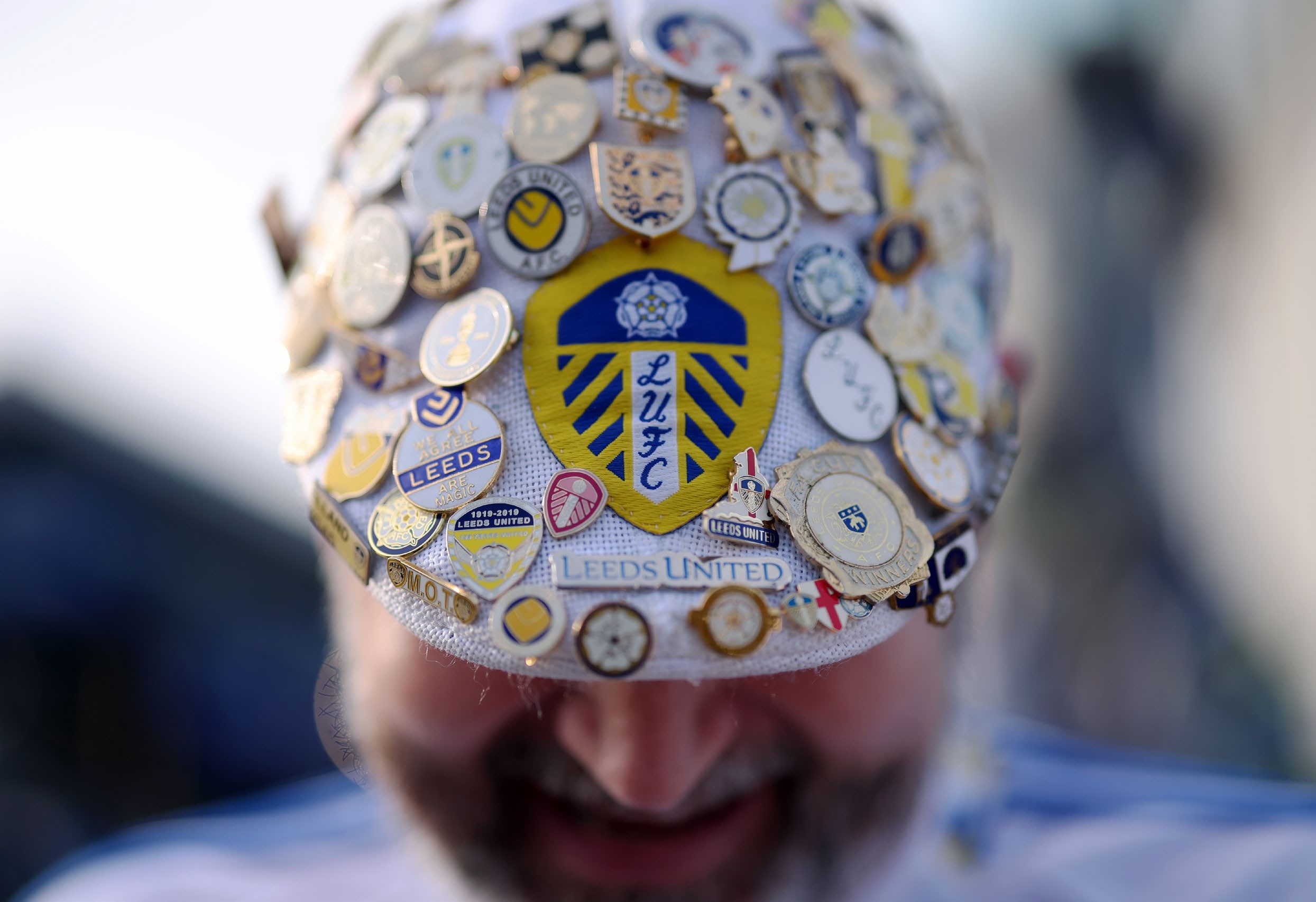 A detailed view of a Leeds United supporter's hat decorated with Leeds United pin badges. (Photo by Carl Recine/Getty Images)
