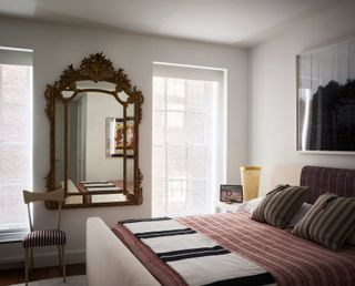 Small bedroom with large antique mirror