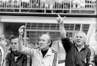 West Germany manager Helmut Schon and assistant manager Jupp Derwall gesture from the bench during the 1974 World Cup group match against Yugoslavia