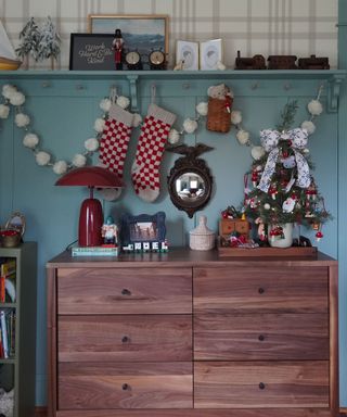 A child's bedroom room dresser decorated with playful vintage christmas decor