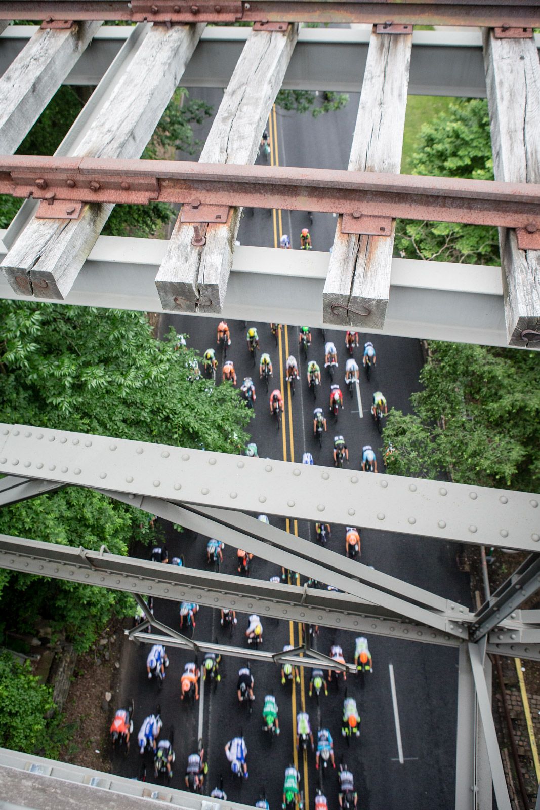 Riders pass under a bridge along the route