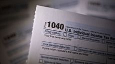 A 1040 tax sheet is seen.