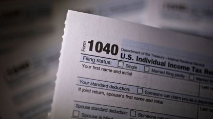 A 1040 tax sheet is seen.
