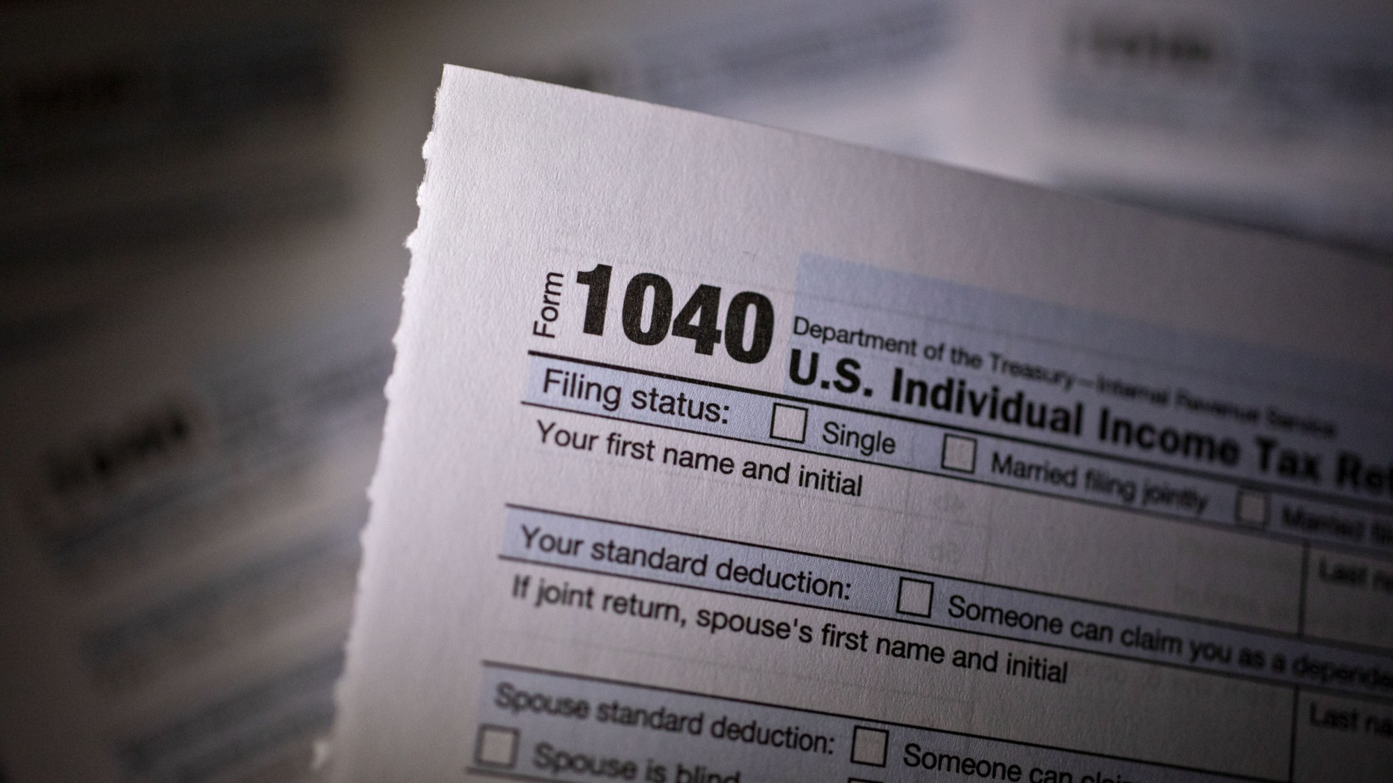 A 1040 tax sheet is seen.