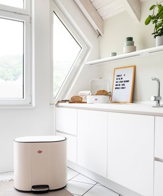 A white kitchen with Wesco Living kitchen trash can